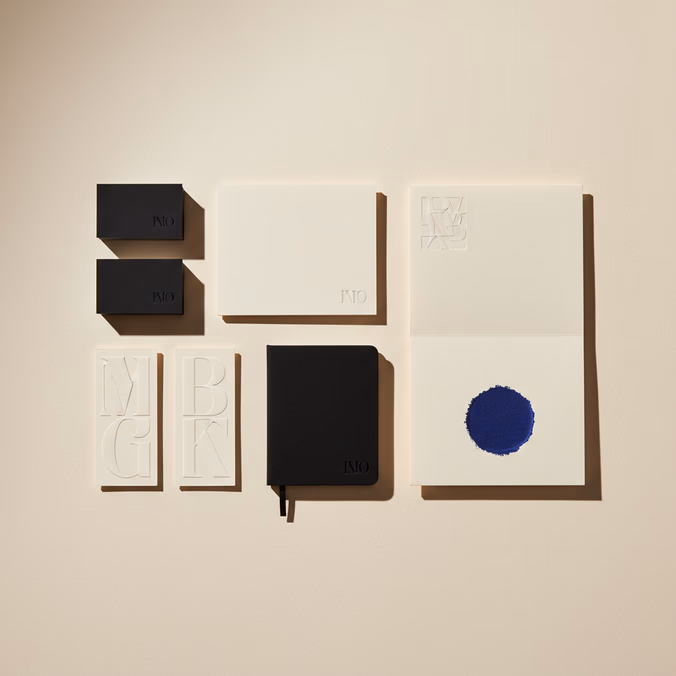 Brand identity system laid out flat — business cards, letterhead, indigo paint swatch, and type specimens